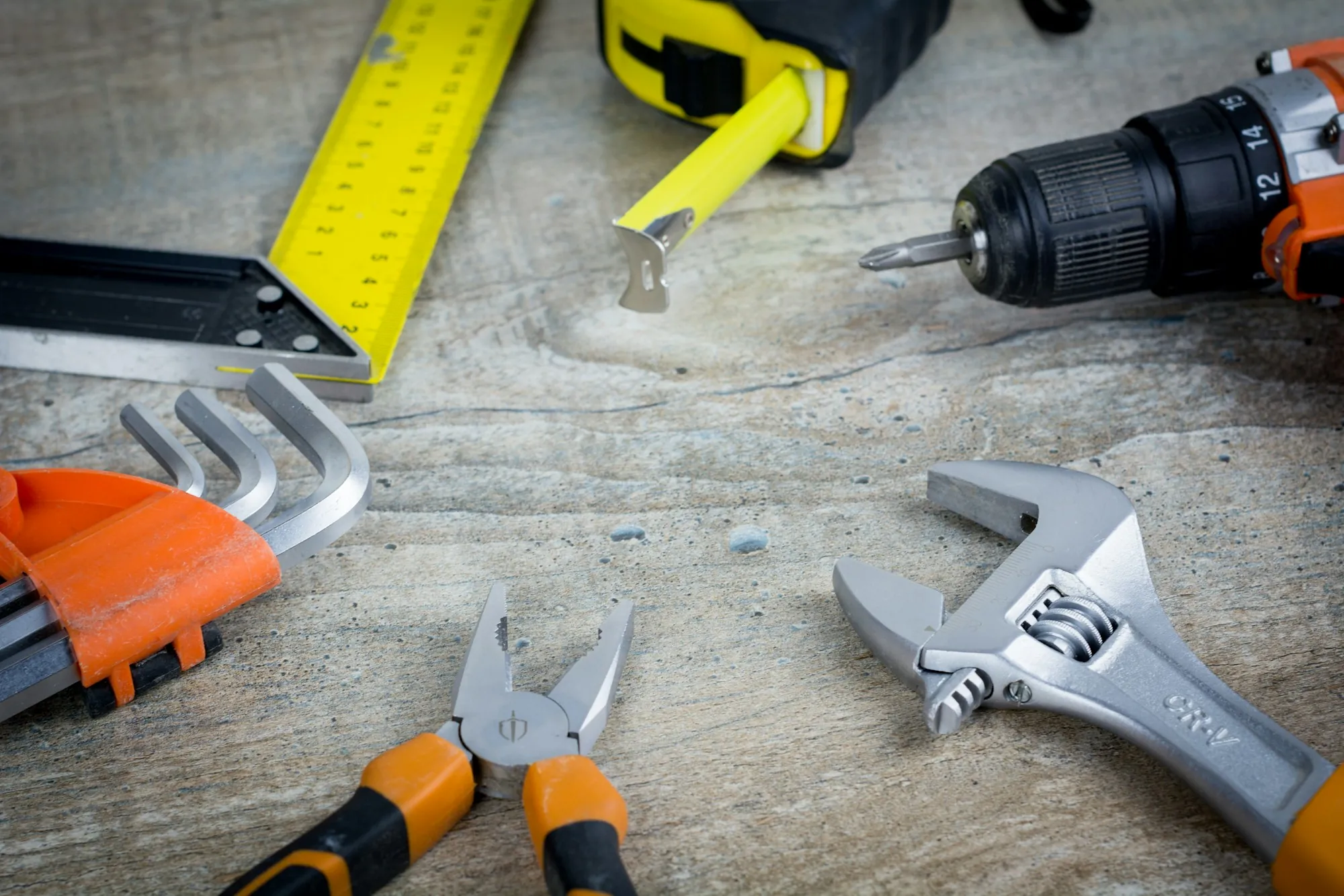 Wrench, pliers and hand tools on a workbench