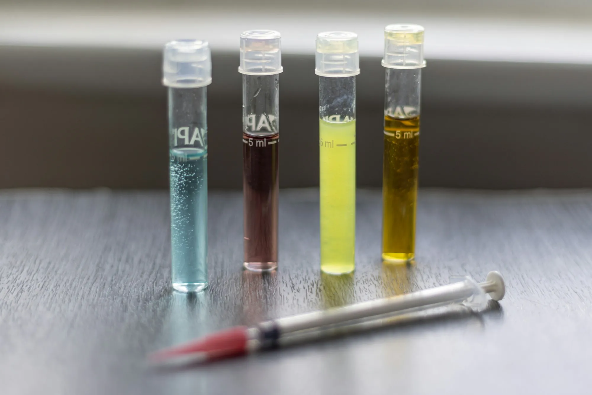 On-site water testing in Aliso Viejo Four test tubes of water samples beside a dropper on a table