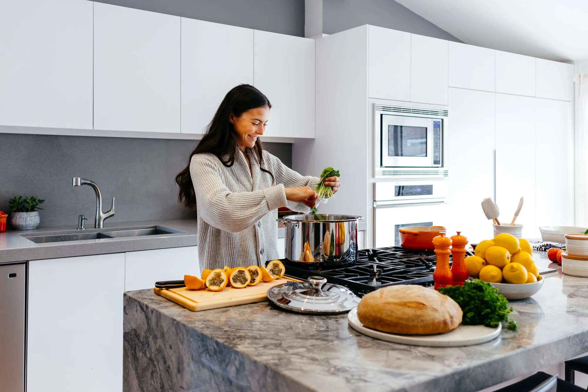 About Aliso Viejo Water Pros Woman cooking in a bright white kitchen